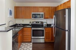 Medford apartment for rent - a kitchen with stainless steel appliances and wooden cabinets
