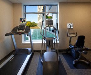 Medford apartment for rent - a gym with cardio equipment and a window