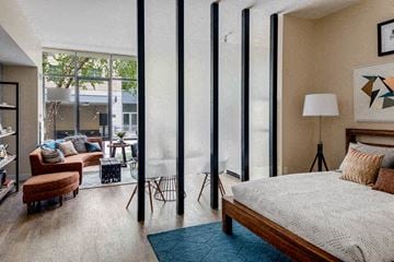 Medford apartment for rent - a bedroom with a bed and a living room with a couch