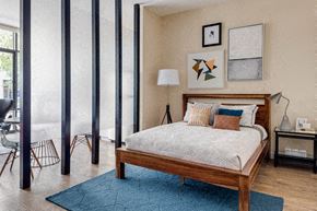Medford apartment for rent - a bedroom with a bed and a blue rug