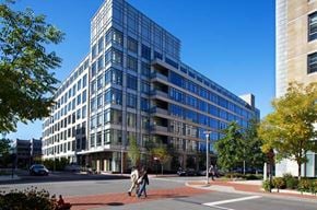 Medford apartment for rent - people crossing a street in front of a large building