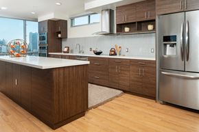 San Francisco apartment for rent - San Francisco Apartments - Etta - Spacious Kitchen With Wood-style Cabinets and Flooring. Kitchen Also Includes Stainless Steel Appliances and a Kitchen Island with a White Countertop.