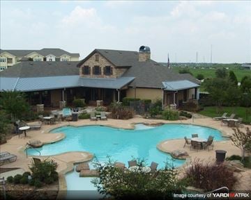 Houston apartment for rent - a large swimming pool in front of a house