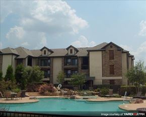 Houston apartment for rent - a large swimming pool in front of a building