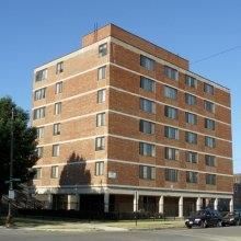 Chicago apartment for rent - a brick building with a car parked in front of it