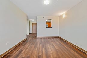 Chicago apartment for rent - an empty living room with wood flooring and white walls