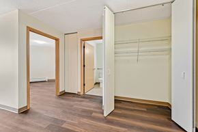 Chicago apartment for rent - an empty bedroom with white walls and wood flooring and a closet