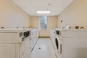 Chicago apartment for rent - an empty laundry room with washes and dryers in it