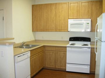 Phoenix apartment for rent - a kitchen with white appliances and wooden cabinets
