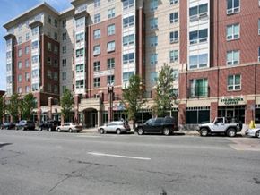 Quincy apartment for rent - a city street with cars parked in front of tall buildings