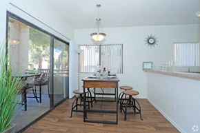 Las Vegas apartment for rent - a dining room with a table and stools and a balcony