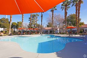Las Vegas apartment for rent - our resort style swimming pool is surrounded by palm trees and umbrellas