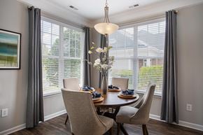 Chapel Hill apartment for rent - a dining room with a table and chairs and large windows