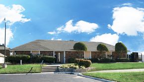 Broken Arrow townhouse for rent - the front of a brick house with a lawn and shrubs