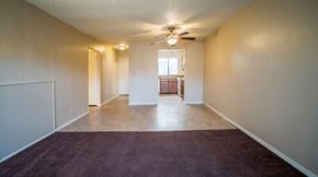 Broken Arrow townhouse for rent - an empty living room with carpet and a ceiling fan