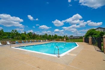 Lounge chairs on sundeck by large pool