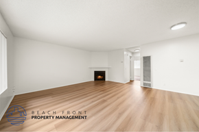 Long Beach apartment for rent - A spacious room with a fireplace and wooden flooring.