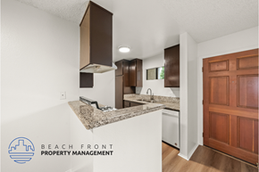 Long Beach apartment for rent - A kitchen with a granite countertop and wooden cabinets.