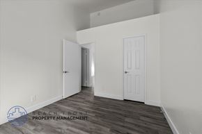 Long Beach apartment for rent - the living room of an apartment with white walls and wood flooring