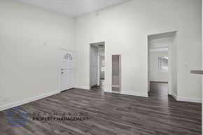 Long Beach apartment for rent - a living room with white walls and wood floors