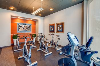 24-Hour fitness studio with cardio theater and free weights