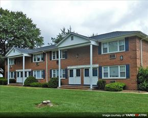 Denville apartment for rent - A brick house with a white door and windows.