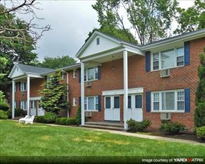 Denville apartment for rent - A brick house with a white door and windows.