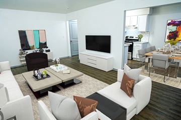 Canton apartment for rent - A modern living room with a white sofa set and a television.