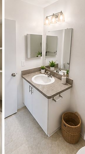 Madison Heights apartment for rent - A bathroom with a sink, mirror, and a basket.