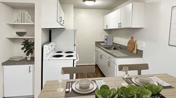 Madison Heights apartment for rent - A white kitchen with a table set for two.