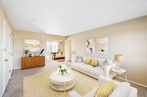 Troy apartment for rent - A living room with a white couch, a coffee table, and a lamp.