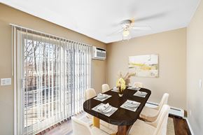 Troy apartment for rent - A dining room with a table set for six.