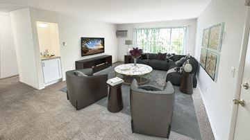 Detroit apartment for rent - A living room with a grey couch and a television.
