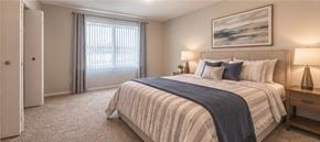 Southfield apartment for rent - A bedroom with a large bed and a painting on the wall.