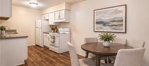 Southfield apartment for rent - A kitchen with a table and chairs and a painting on the wall.