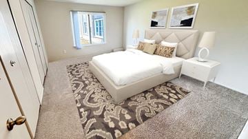 Southfield apartment for rent - A bedroom with a large bed and a window.