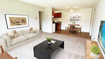 Farmington Hills apartment for rent - A living room with a couch, coffee table, and a painting on the wall.