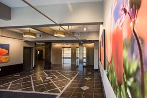 Newark apartment for rent - Lobby with black and white designed tile floors and colorful paintings on the wall