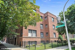 Chicago apartment for rent - a brick building with a street sign in front of it