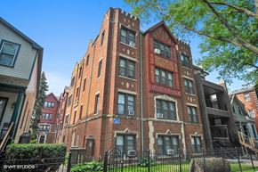 Chicago apartment for rent - a tall brick building with a fence in front of it