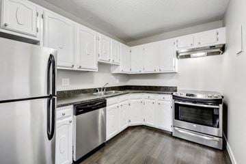 Calgary apartment for rent - A kitchen with white cabinets and stainless steel appliances.