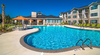 Resort-style swimming pool with sun shelf and expansive sundeck