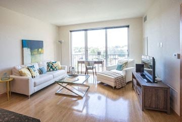 St. Louis Park apartment for rent - A living room with a white couch and a painting on the wall.