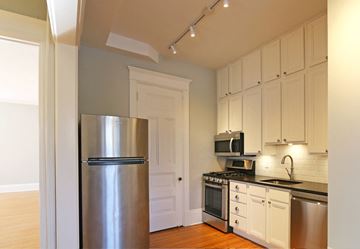 St. Paul apartment for rent - a kitchen with stainless steel appliances and white cabinets
