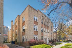 Denver apartment for rent - A large brick building with a tree in front of it.