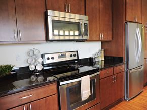 Brookfield apartment for rent - a kitchen with stainless steel appliances and black counter tops