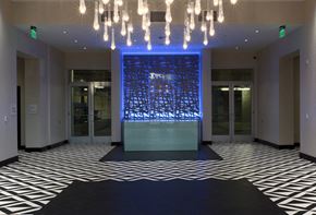 West Hollywood apartment for rent - A hallway with a black and white checkered floor and a blue lighted wall.