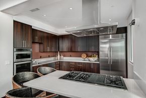 West Hollywood apartment for rent - A modern kitchen with a stainless steel refrigerator and wooden cabinets.