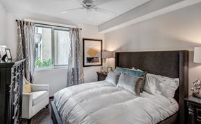 West Hollywood apartment for rent - A bedroom with a large bed and a ceiling fan.