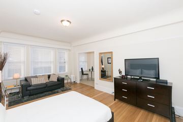 San Francisco apartment for rent - A living room with a black couch and a television on a cabinet.